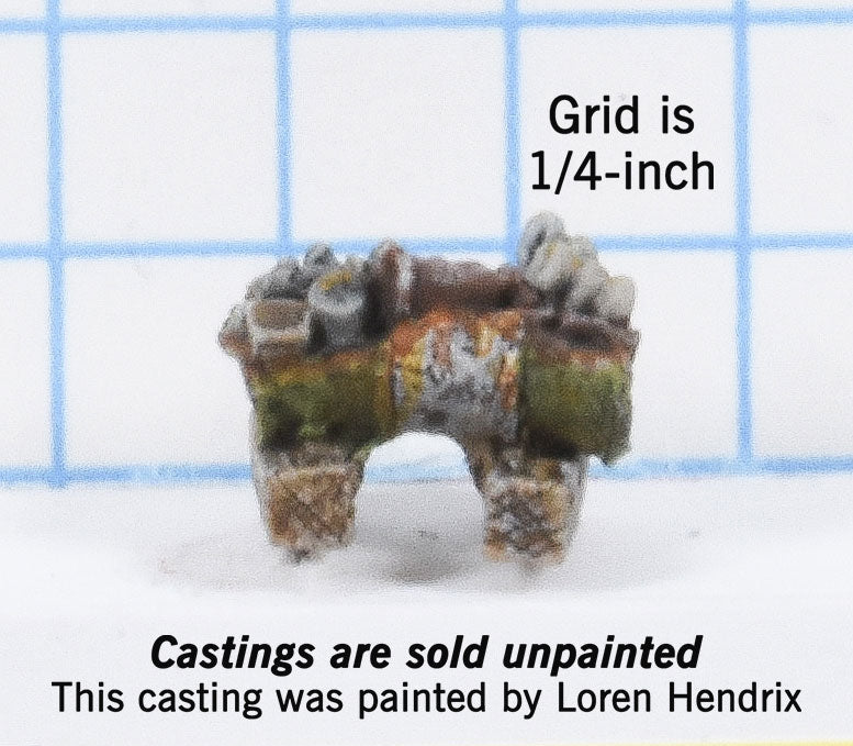 Drum on blocks cut in half and filled with junk 